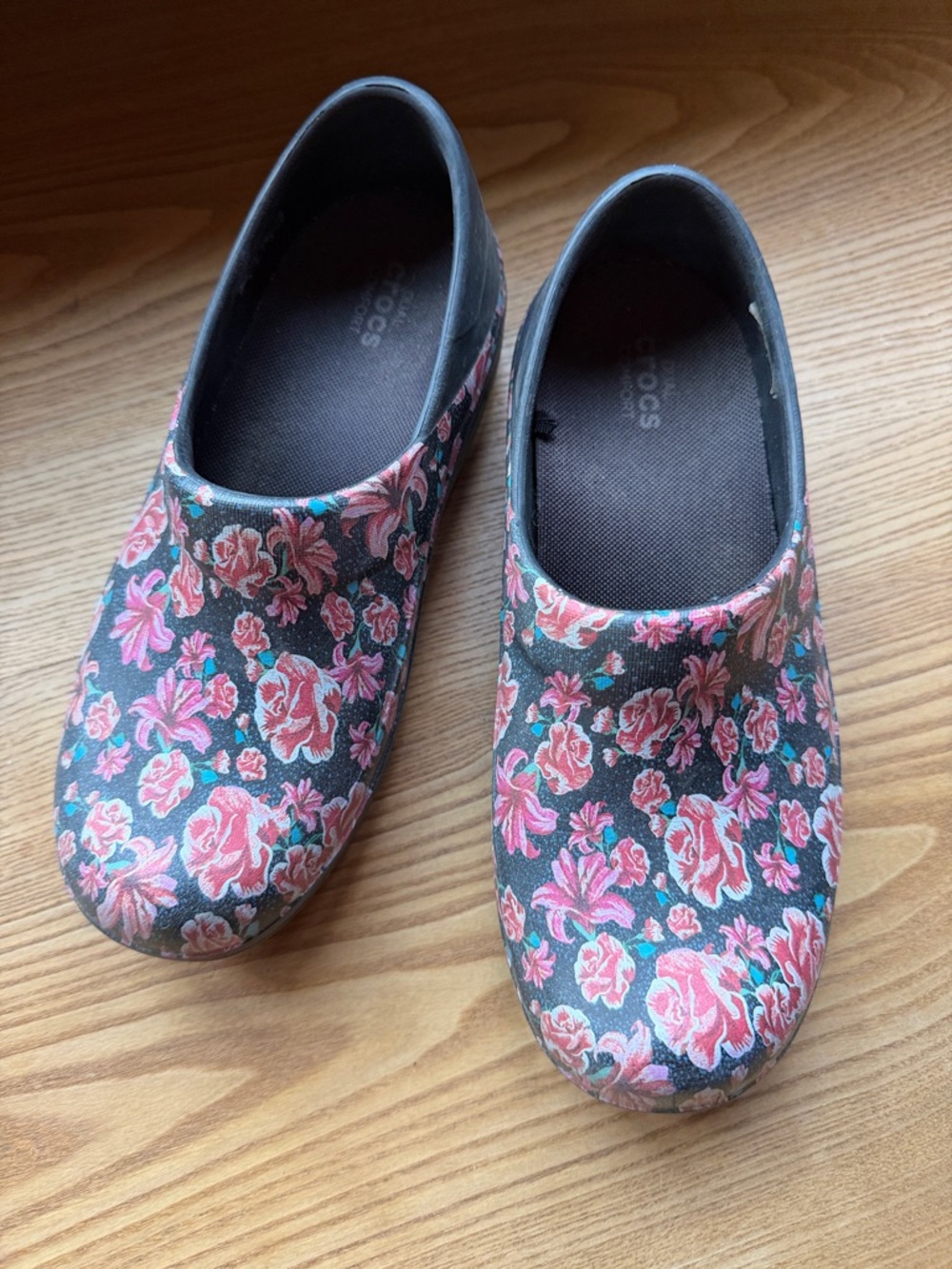CROCS Black Floral-Patterned Slip-On Clogs with Pink and Teal Accents